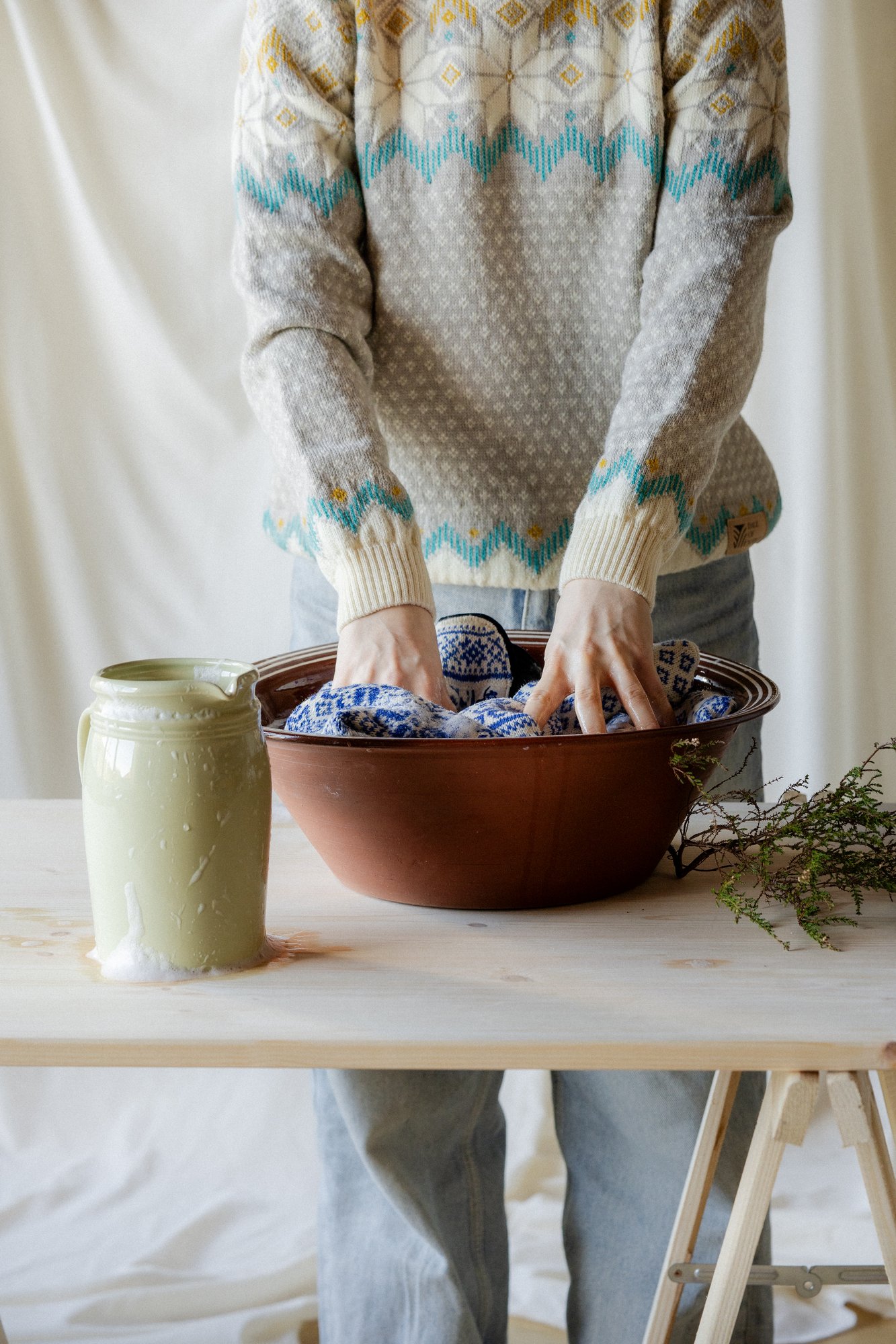 Woman handwashing a Dale of Norway wool sweater