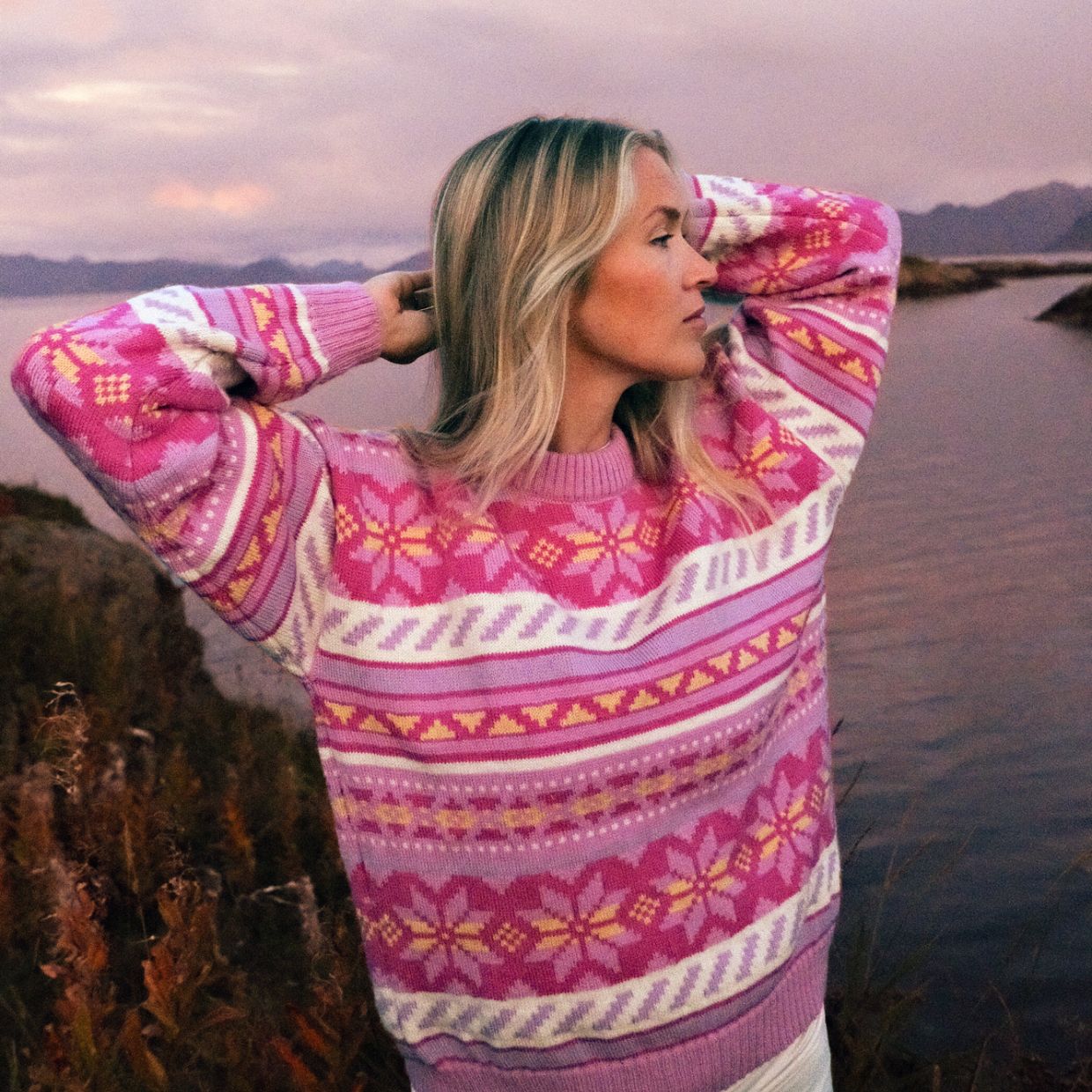 Ingrid Hennig wearing the Ingrid sweater from Dale of Norway during sunset in Lofoten