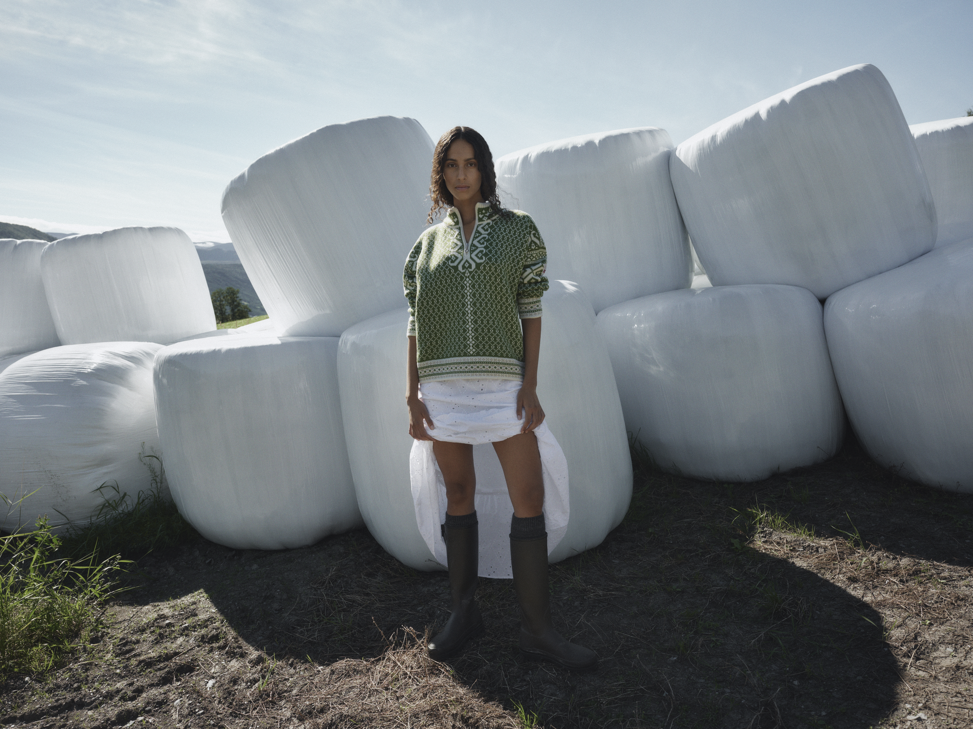 Female model wearing a green wool sweater, Leknes, from Dale of Norway